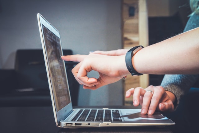 hand touching a computer screen