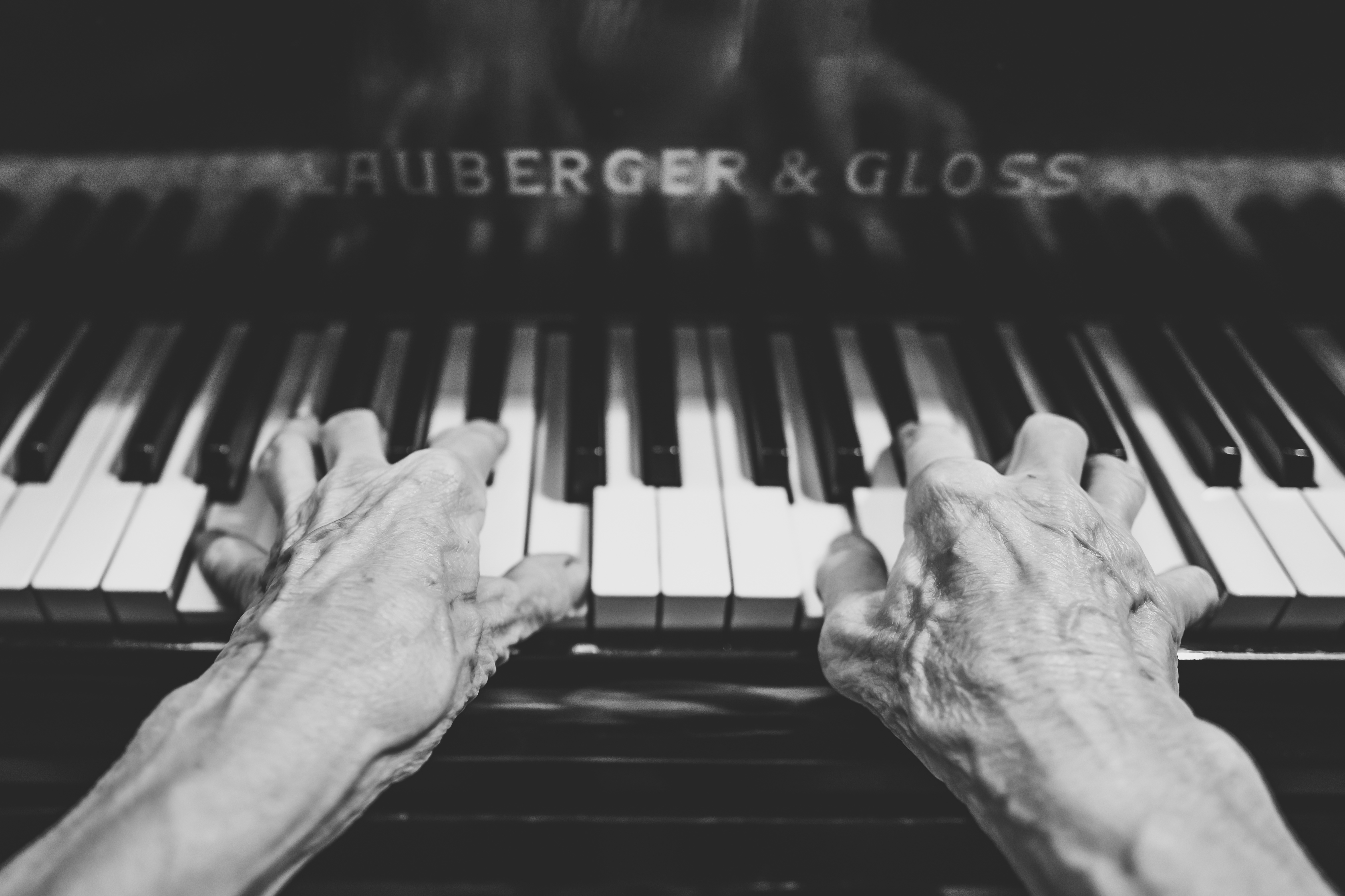 Old hands playing keyboard
